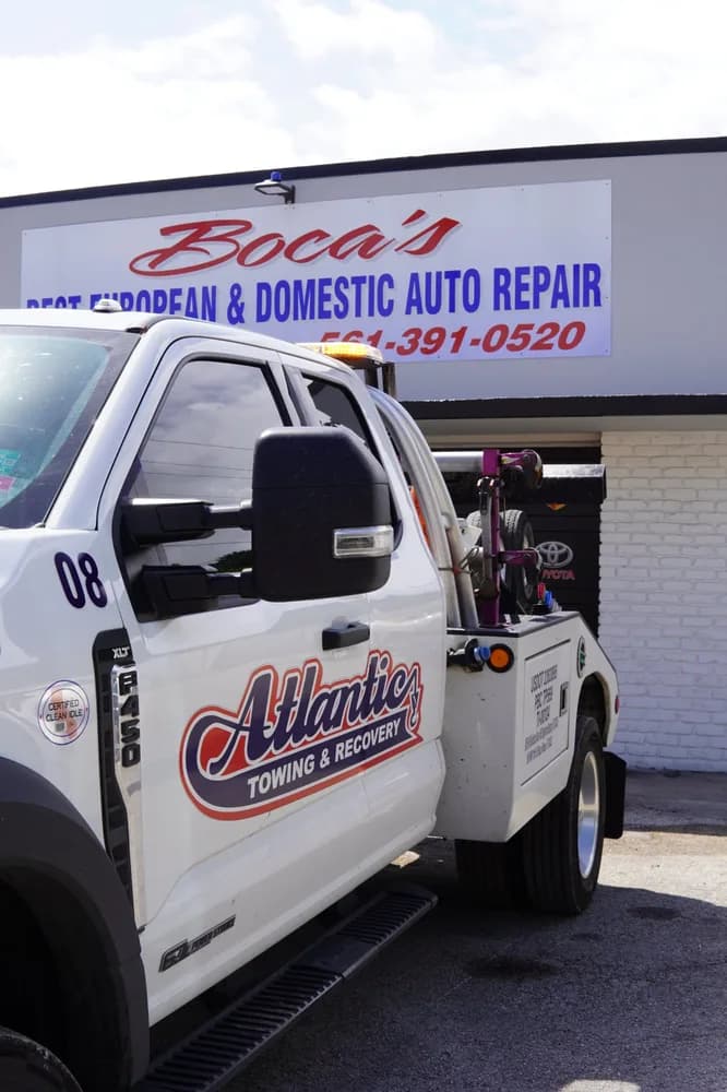 Atlantic Towing truck parked in front of Boca's Best Auto Repair
